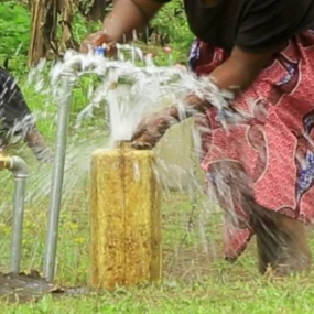 Woman-fills-water-at-new-public-stand-post.-Kabarole-District,-Uganda.--30-September-2025