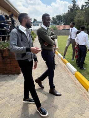 Aman-Nabutula-and-Jenaro-Mogire-exit-the-Langata-Ward-building-in-Nairobi,-following-the-Nairobi,-Kenya-Temple-dedication,-May18th,-2025