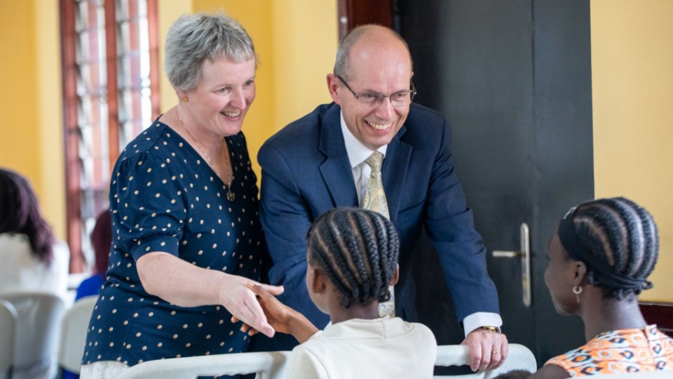 Elder-Giraud-Carrier,-Second-Counselor-in-the-Africa-Central-Area-Presidency,-and-his-wife-Sister-Isabelle-Sophie-Mauclair-welcome-members-to-the-YSA-Devotional-on-February-15,-2025,-in-Yaounde,-Cameroon.