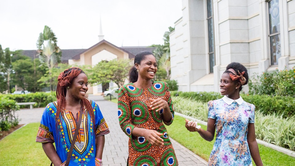 Women walking happily at the Ghana, Accra temple grounds.