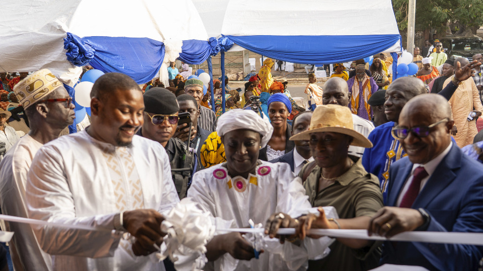 Elder Kyungu, with attending dignitaries, cuts the ribbon officially handing over the donation on 11 June, 2025.