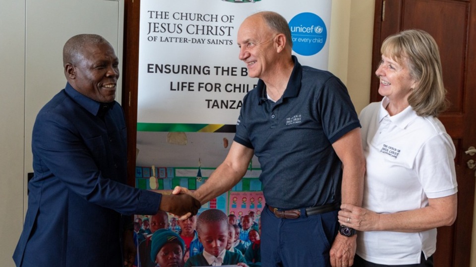 Dr. Frank George Haule Hawassi (Administrative Secretary of Songwe Province) shakes hands with Elder Pieper, Area Presidency, as Sister Pieper looks on in Songwe, Tanzania on August 26th, 2025