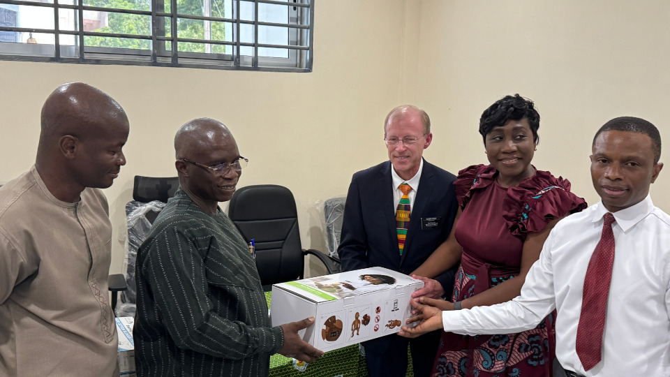 Dr. Visick (center, and President Okonkwo (far right) participate in ceremonial handover of equipment to Dr. Ofosu.
