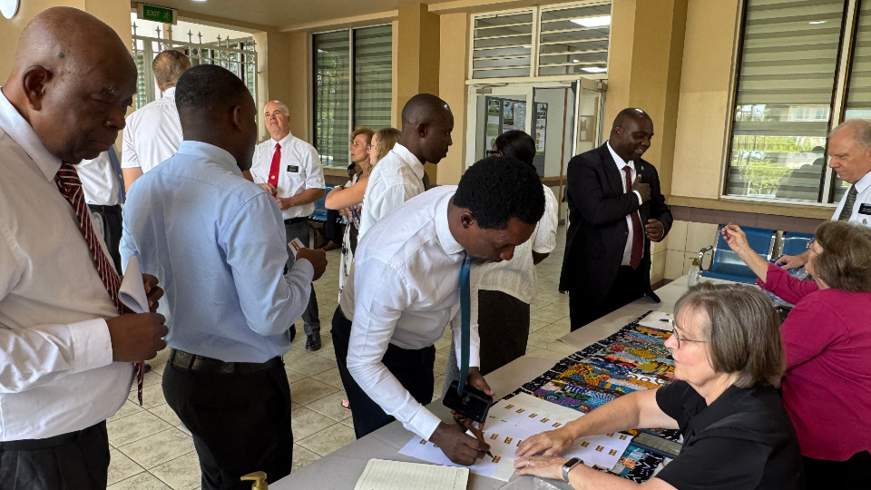 Attendees register and get name tags for the reunion held on 5 September, 2025.